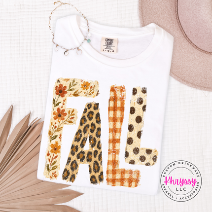 White shirt featuring autumn-patterned FALL text design.