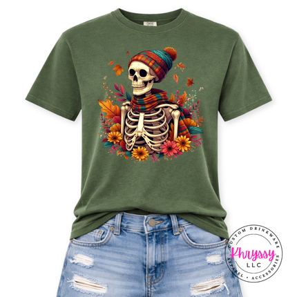 Hemp tee with an illustrated fall skeleton design surrounded by autumn blooms.