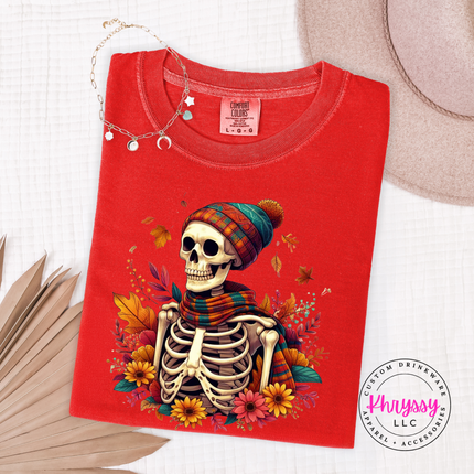 Woman wearing a Red tee with the cozy fall skeleton in a beanie graphic