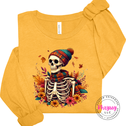 Heather mustard long sleeve tee with a cozy skeleton among autumn florals.