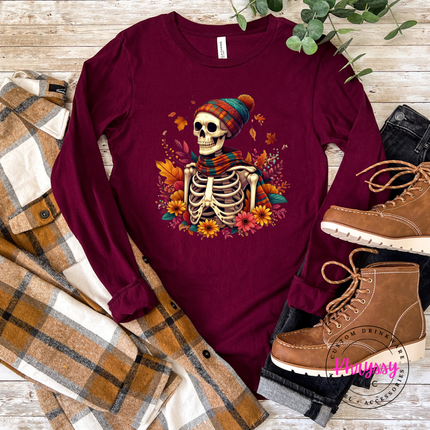 muave long sleeve tee featuring a scarf-wearing skeleton and rust floral accents.