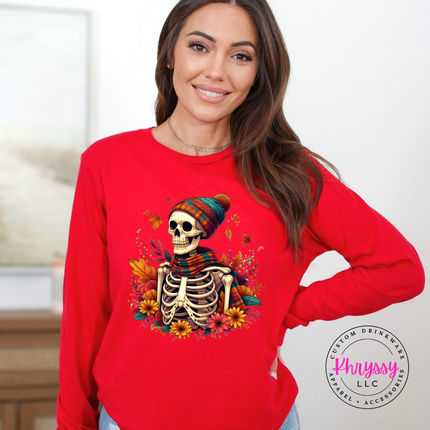Red long sleeve tee with the cozy fall skeleton in a beanie graphic