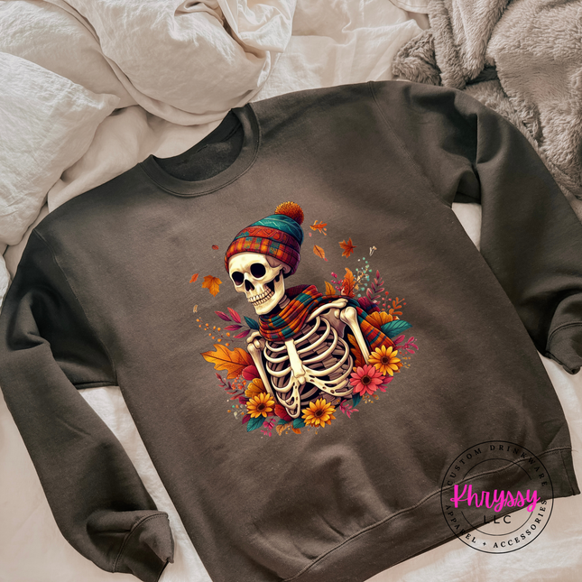 Woman wearing a Dark Chocolate crewneck sweatshirt with a fall skeleton design.