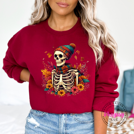 Garnet crewneck sweatshirt with an illustrated autumn skeleton graphic print.