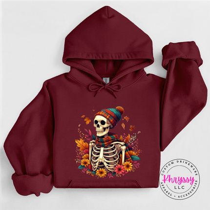 Garnet pullover hoodie with an illustrated fall skeleton graphic print.