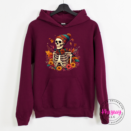 Maroon pullover hoodie with a hand-illustrated skeleton and floral fall design.