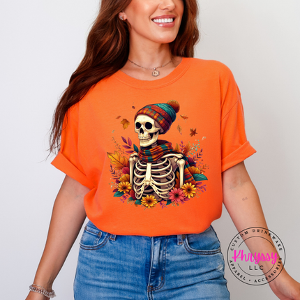 Woman wearing a Burnt Orange graphic tee with a cozy skeleton and autumn florals.