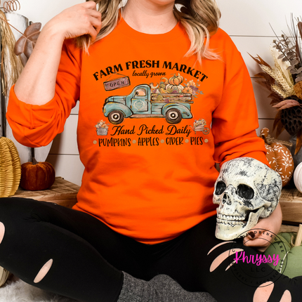 Orange crewneck sweatshirt featuring a vintage farm truck print.