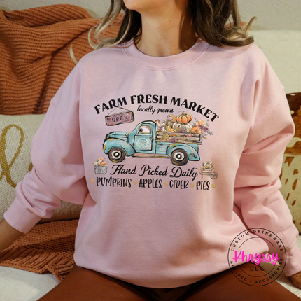 Light pink colored crewneck sweatshirt with a hand-illustrated market graphic.