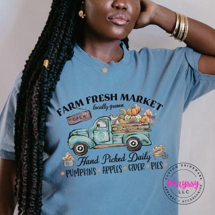 Woman wearing a Blue jean tee with a vintage farm truck design.