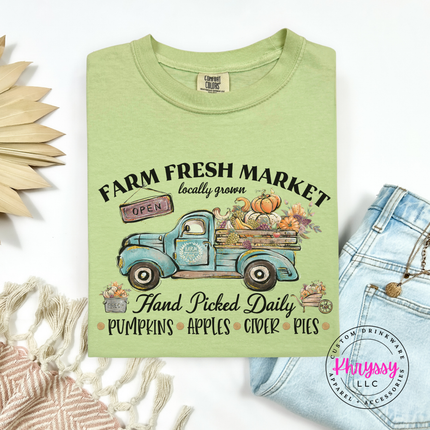Celadon tee featuring a farm truck loaded with pumpkins and apples.