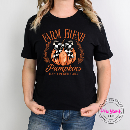Black tee featuring a checkered bow pumpkin and laurel leaves.