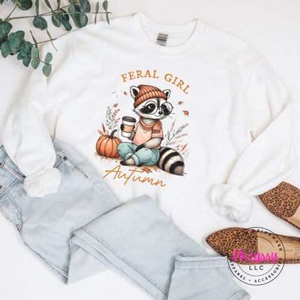 White crewneck sweatshirt with a hand-illustrated raccoon and pumpkin print.