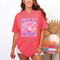 Woman wearing a neon orange funny faith statement tee with raccoon