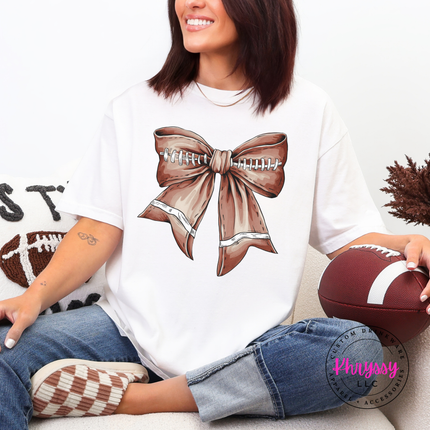 White colored tee with a cute football bow game day graphic.