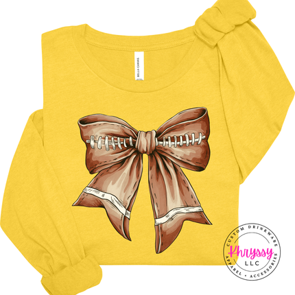 Heather Yellow Gold long sleeve tee with the football season coquette bow print
