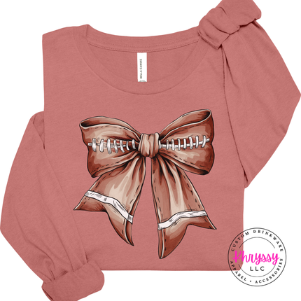 Close-up of a football lace bow graphic on a Mauve colored long sleeve.
