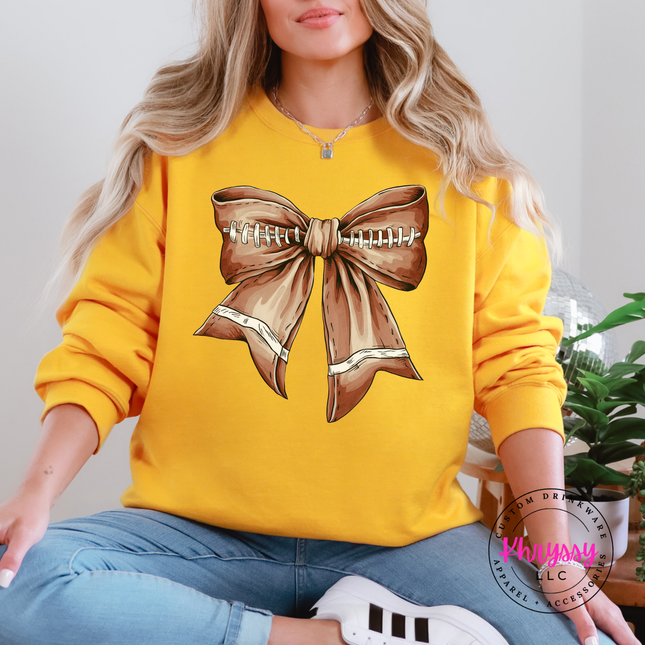 Gold crewneck sweatshirt with the football season coquette bow print