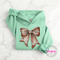 Mint hoodie with a cute football bow game day graphic.
