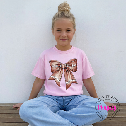 Blossom garment-dyed tee featuring a game day football bow design.