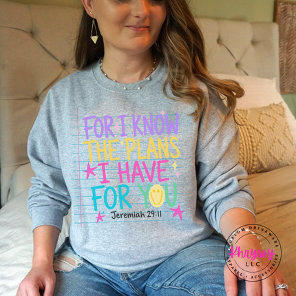 Woman wearing a Sport Grey crewneck sweatshirt with the colorful Jeremiah 29:11 design