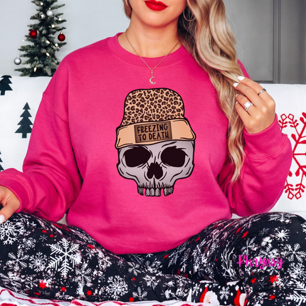 Woman wearing the Freezing To Death skull crewneck sweatshirt in Heliconia.
