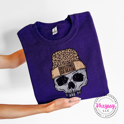 Purple crewneck sweatshirt with a skull in a leopard beanie, Freezing To Death.