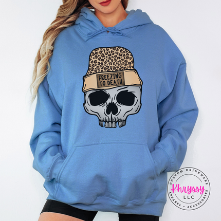 Woman wearing the Freezing To Death skull hoodie in Carolina Blue.