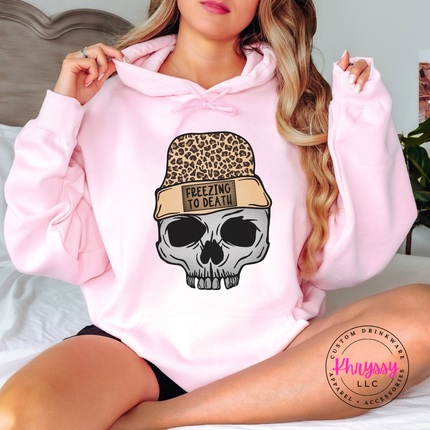 Close up of the Freezing To Death beanie patch on a Light Pink hoodie.