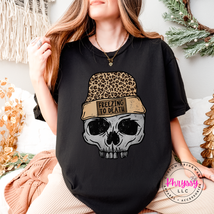 Black tee with a skull in a leopard beanie, Freezing To Death.
