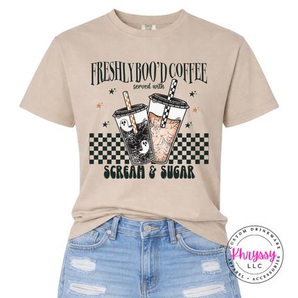 Sandstone Comfort Colors tee showing a playful Freshly Boo'd Coffee graphic.