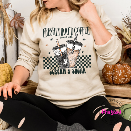 Sand fleece crewneck showing a playful Freshly Boo'd Coffee graphic.