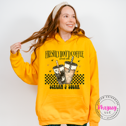 Gold hoodie with kangaroo pocket showing a Halloween coffee print.