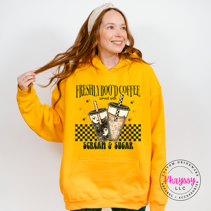 Gold hoodie with the scream and sugar checkered Halloween coffee graphic