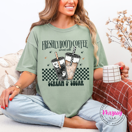 Woman wearing a Bay Comfort Colors tee with a Halloween coffee cup graphic.
