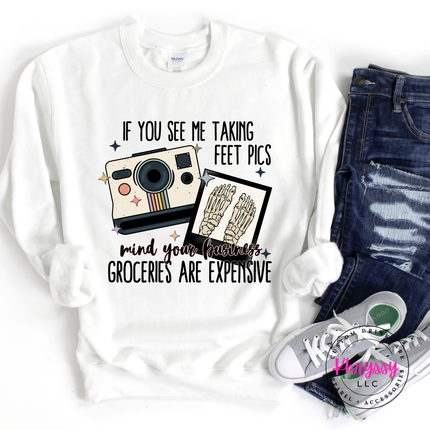 White sweatshirt with graphic design and text, paired with jeans and sneakers on a white background.