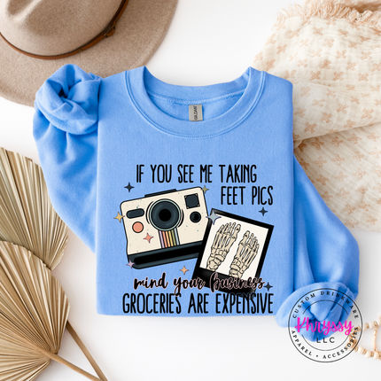 Blue crewneck with a camera graphic and text on a white background