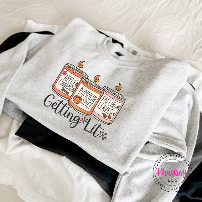 Ash colored crewneck sweatshirt featuring a Getting Lit candle design.