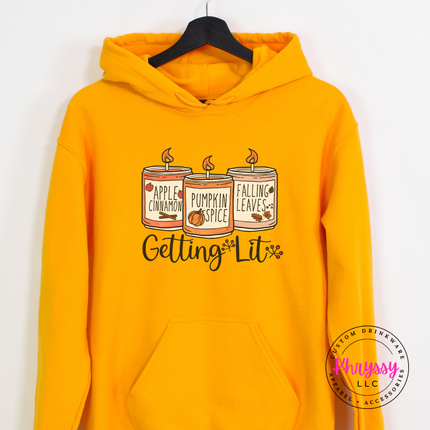 Gold hoodie with the cozy fall candles script graphic
