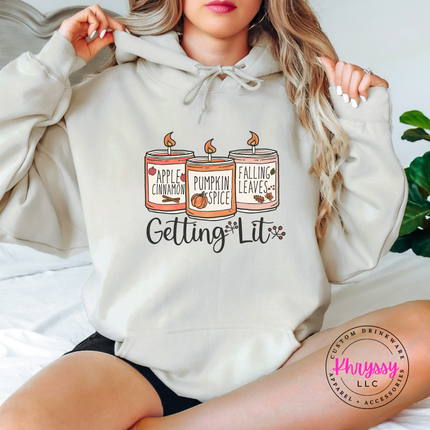 Sand hoodie with the Getting Lit fall candles graphic