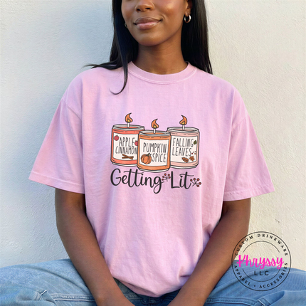Woman wearing a Blossom tee with a Getting Lit candle design.