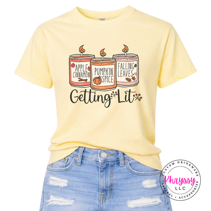Butter colored graphic tee featuring three fall candles illustration.