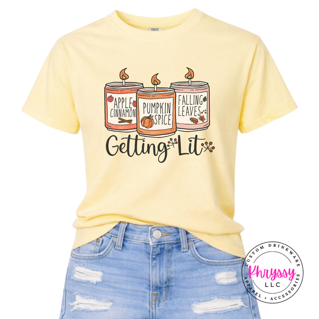 Butter colored graphic tee featuring three fall candles illustration.