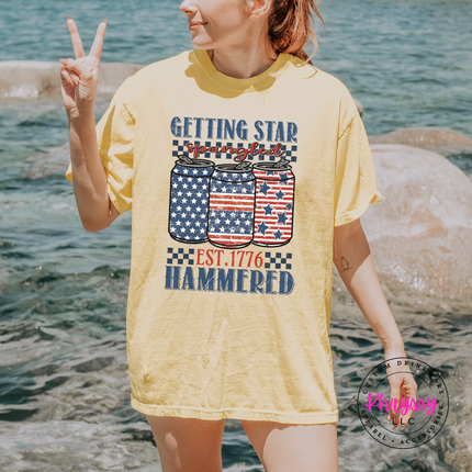 Butter garment-dyed tee with a vintage star-spangled beer-can graphic across the chest.