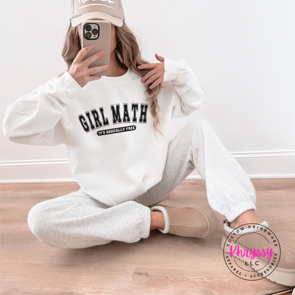 White crewneck sweatshirt worn outdoors, highlighting the varsity graphic.