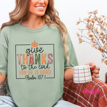 Woman wearing a Bay Comfort Colors tee with a Give Thanks Psalm 107 graphic.