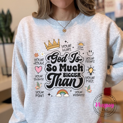 Ash crewneck sweatshirt with a God Is So Much Bigger Than faith graphic and icons.