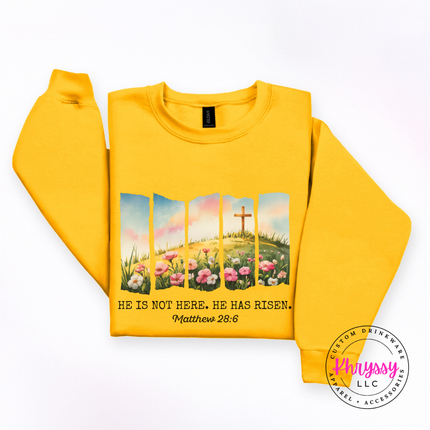 Gold crewneck sweatshirt featuring a watercolor He Has Risen Easter design.