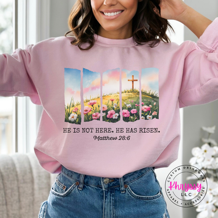 Light Pink crewneck sweatshirt showing a He Has Risen cross and flowers print.