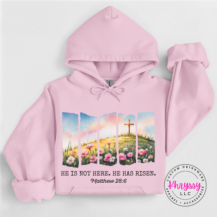 Light Pink pullover hoodie showing a He Has Risen cross and flowers print.